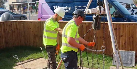 Engineers installing a below ground package pumping station.