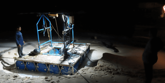 Land reclamation submersible pumping on Maldives beach.