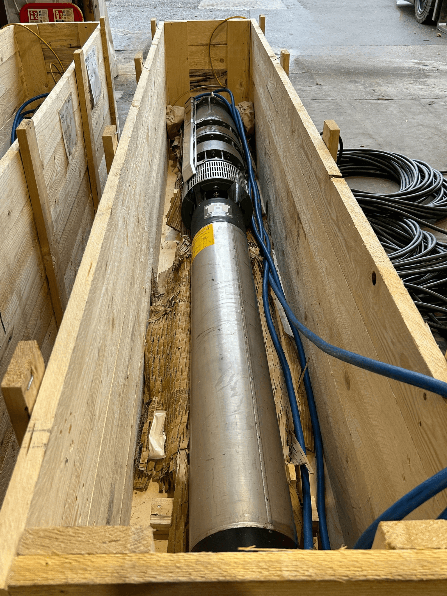 Borehole pump in wooden crate.