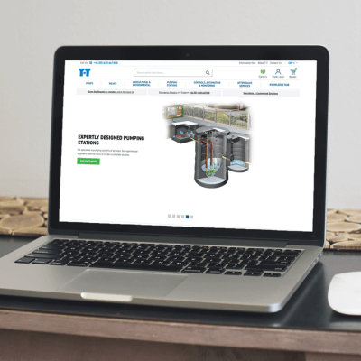 An open laptop dispaying the T-T Pumps website homepage, showing an illustration of a below ground pumping station.